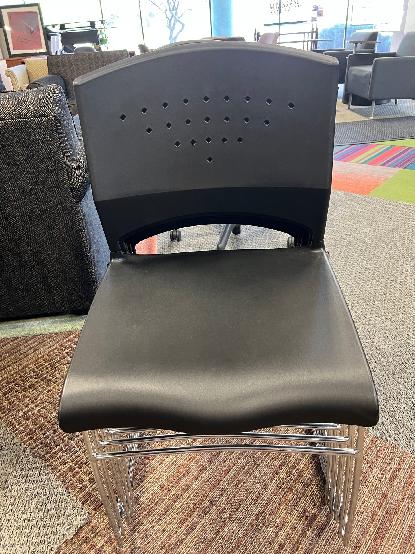 Chair: Stationary chair Black molded plastic on stainless steel frame