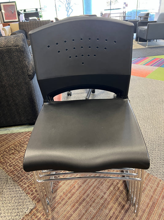 Chair: Stationary chair Black molded plastic on stainless steel frame