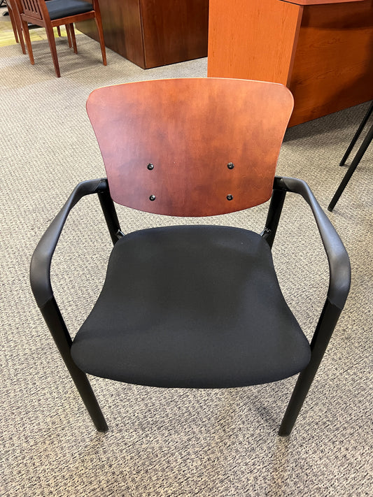 Chairs: Stationary chair with wooden back and black padded seat