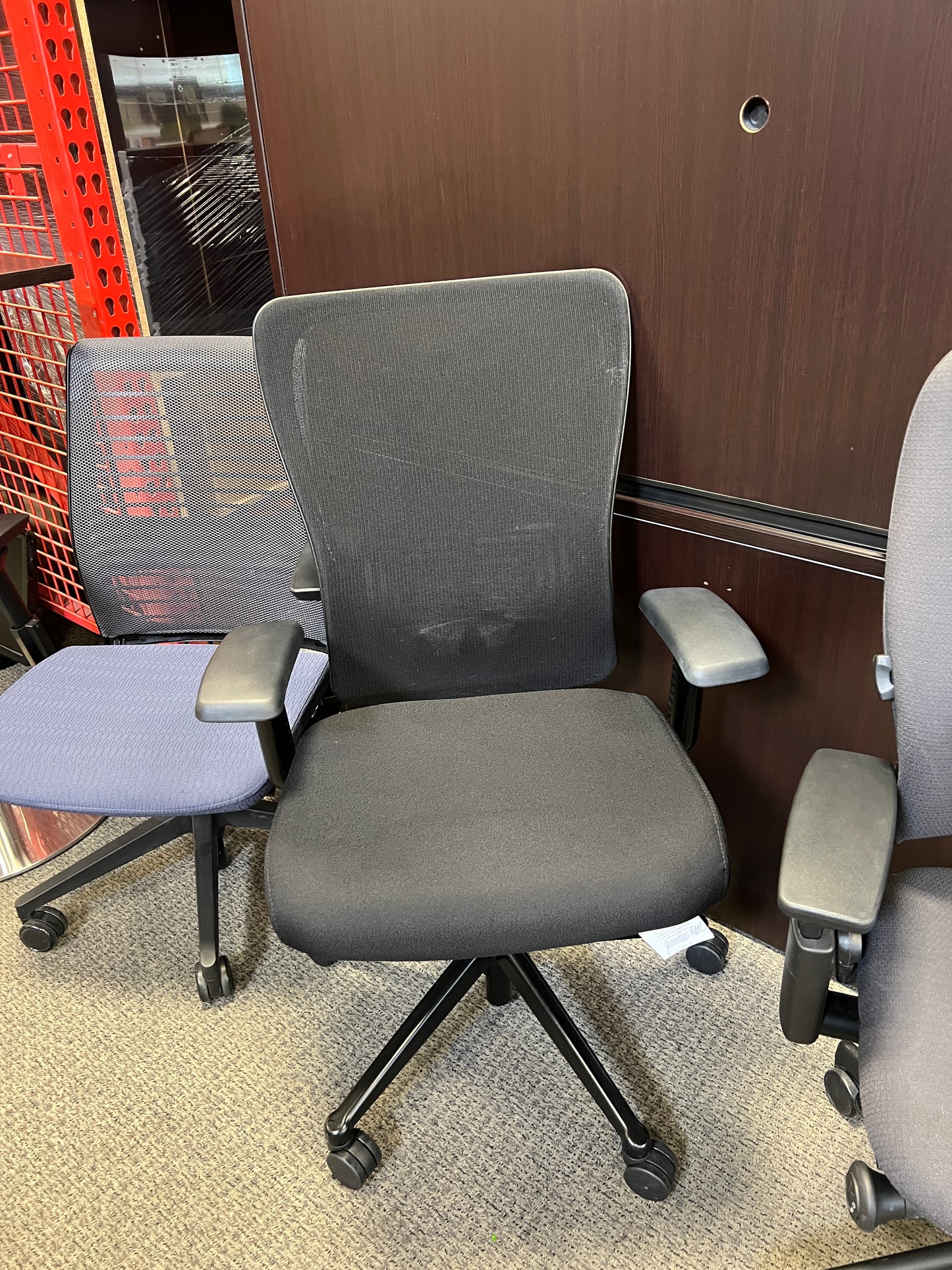 Chairs: Black desk chair with mesh back and black padded seat