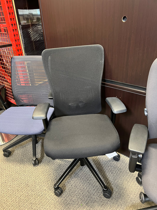 Chairs: Black desk chair with mesh back and black padded seat