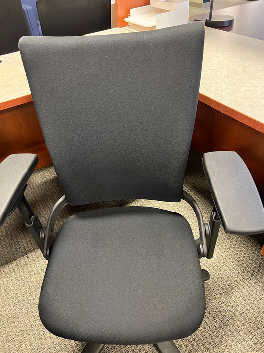 Chairs: Steelcase black desk chair on casters
