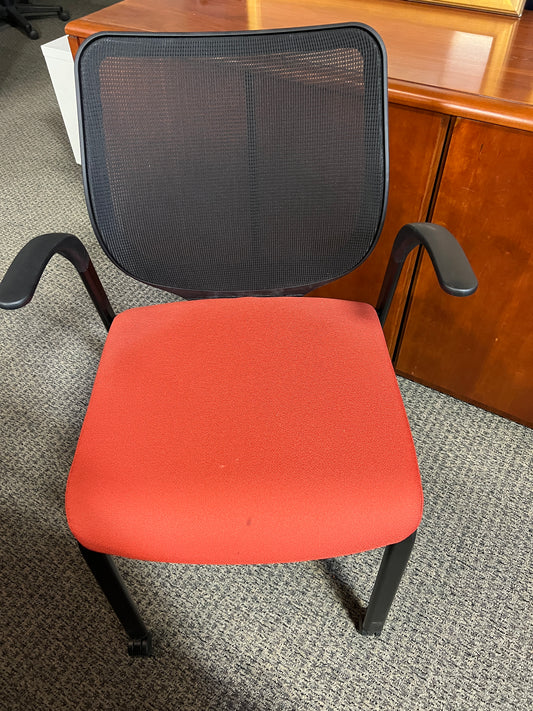Chairs: Steelcase black mesh back with red fabric seat on casters