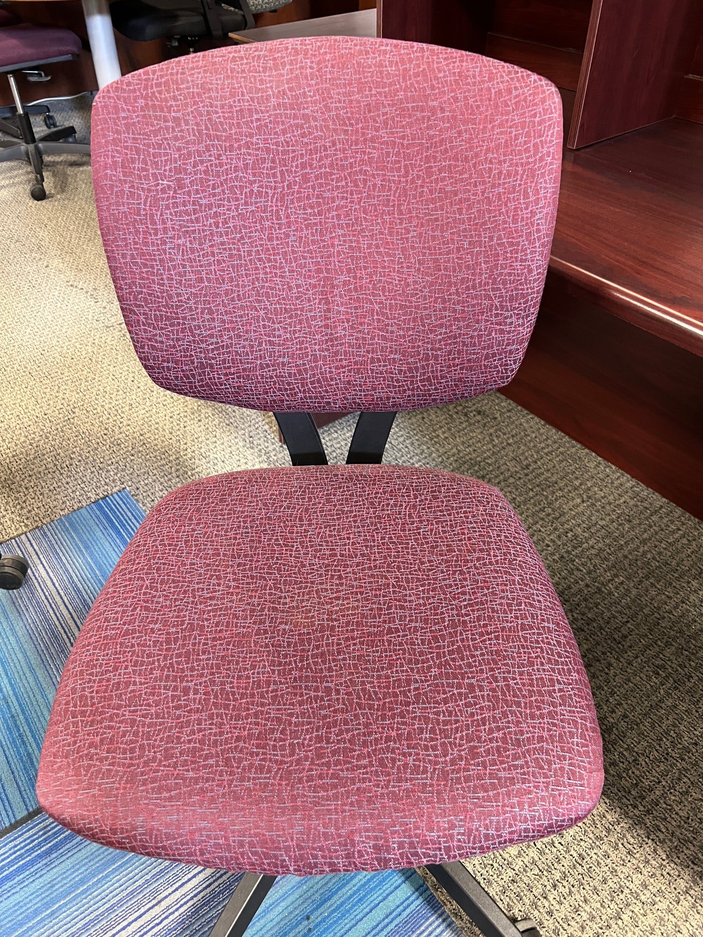 Chairs: Deep red print task chairs on casters